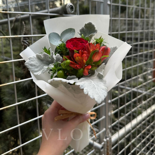 A simple red rose bouquet wrapped in white.