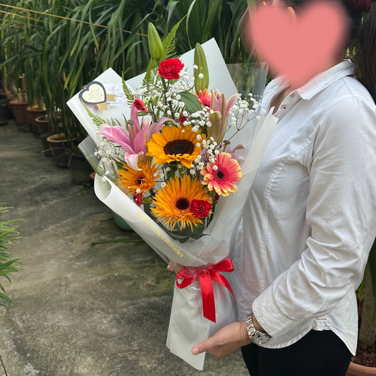 Person holding a colorful bouquet of flowers with a blurred face