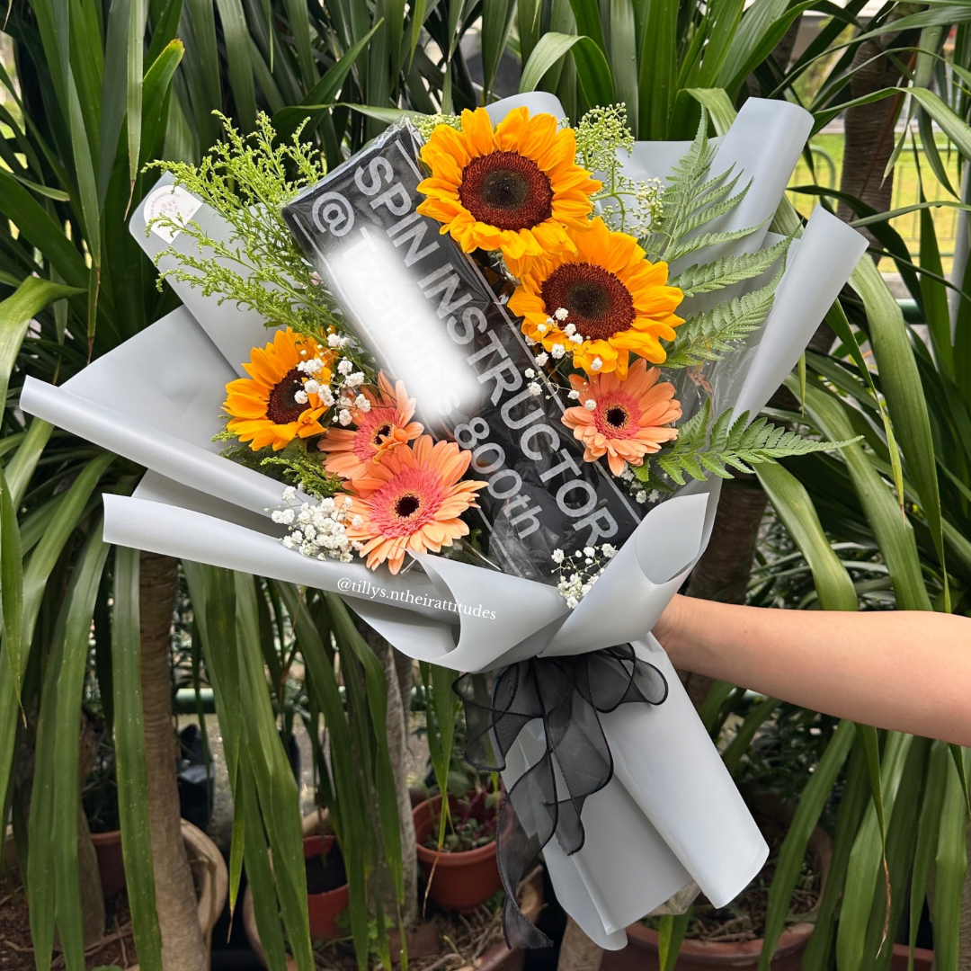 Bouquet of flowers with a customised t-shirt inside the bouquet.